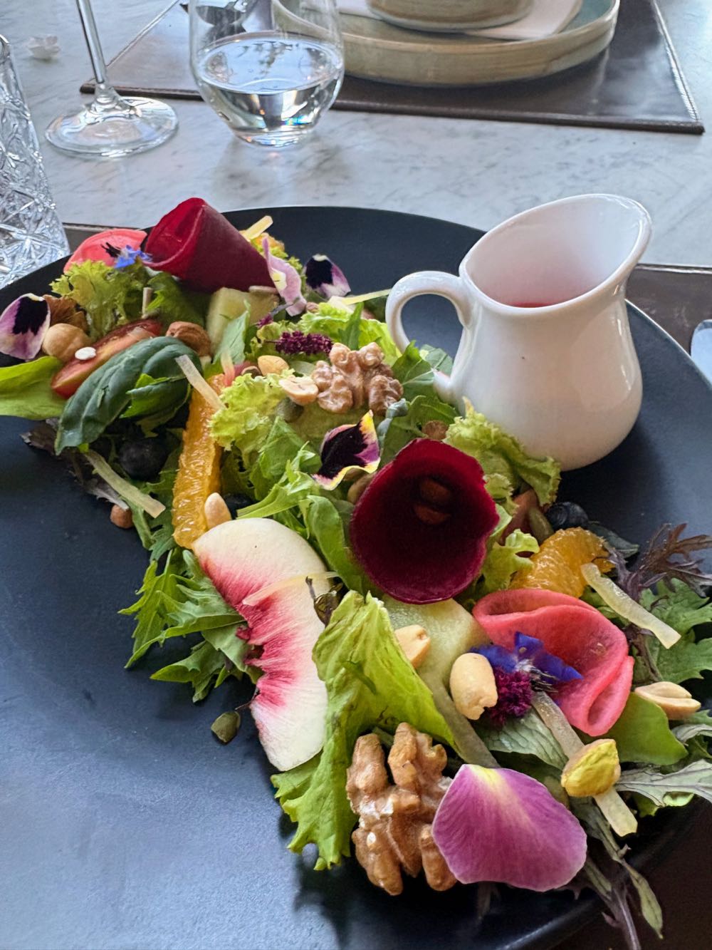 A colorful plated dish of vegetables and flowers at Hotel AWA